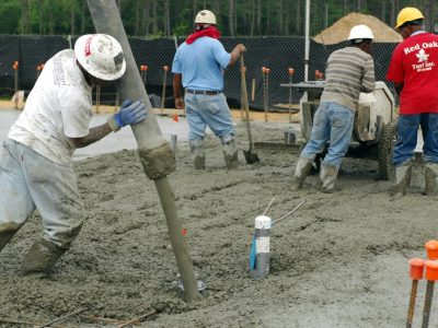 MOODY AIR FORCE BASE, Ga. -- A contractor pours concrete here, April 10. Contractors have been working since 0100 this morning on a two bay fuel cell hanger floor that will take over twelve hours and more than ninety concrete trucks to complete. (U.S. Air Force photo/Staff Sgt. Joshua T. Jasper)